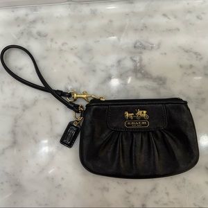 Coach Wristlet. Black Leather. Purple satin liner inside. Excellent condition.